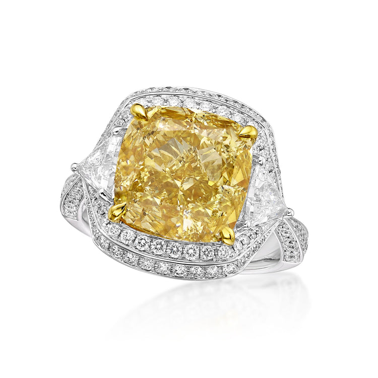 close up of the fancy yellow diamond engagement ring, with white diamonds on either side, around the center stone, and along the ring band.