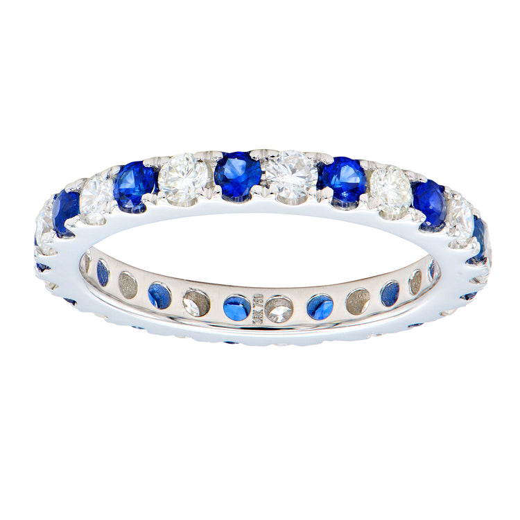Close up of our gorgeous Sapphire and Diamond Eternity Band featuring alternating blue sapphire gemstones and round white diamonds.