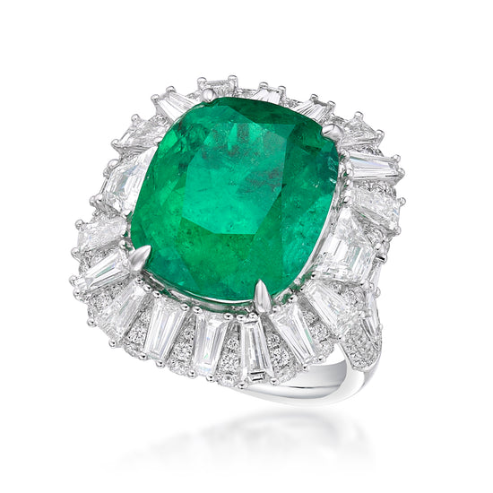 Close up view of the green emerald ring with diamonds. The central 12.19 carat emerald is surrounded by a halo of tapered and round white diamonds. Set in 18k white gold. 