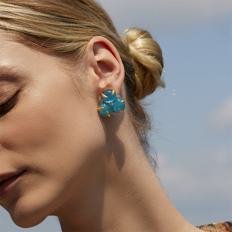 Image of a woman wearing the aquamarine and diamond verdura earrings.