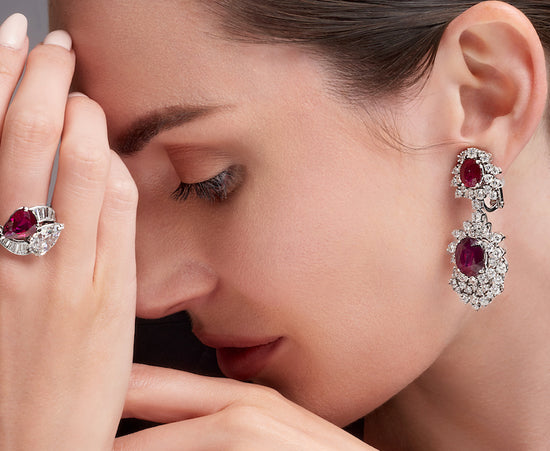 Woman wearing ruby earrings and a ruby ring