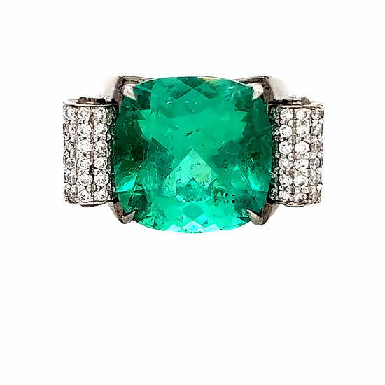 Close up view of the front of the cushion cut emerald engagement ring. The center stone is 10.66 carats. 