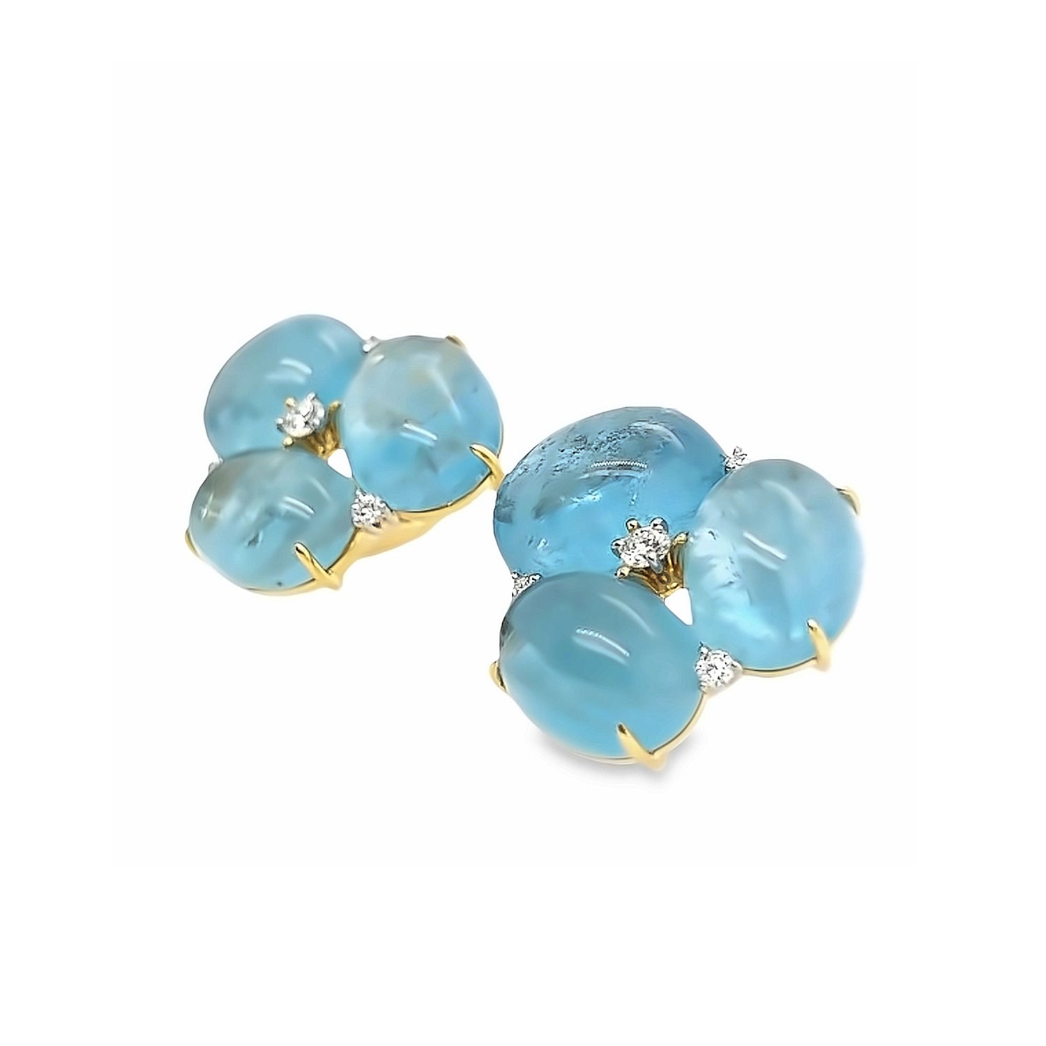 Close up of the Verdura stud earrings, featuring a cluster of blue aquamarine gemstones and round white diamonds set in 18k yellow gold and platinum.