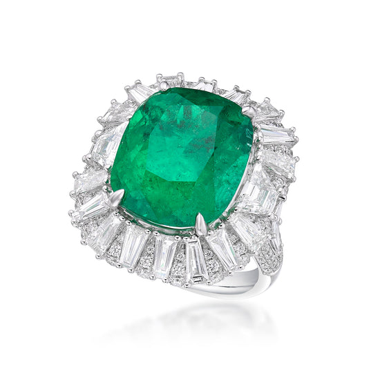 Close up view of the green emerald ring with diamonds. The central 12.19 carat emerald is surrounded by a halo of tapered and round white diamonds. Set in 18k white gold. 