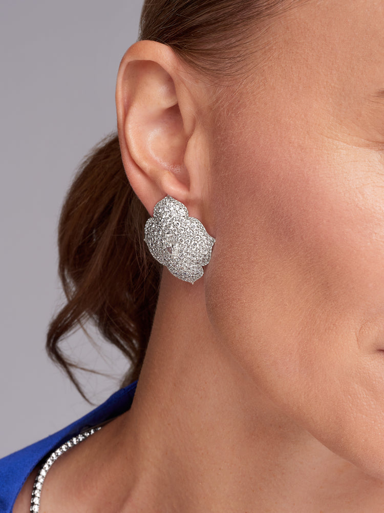 Close up view of a woman wearing the Diamond Flower Earring.