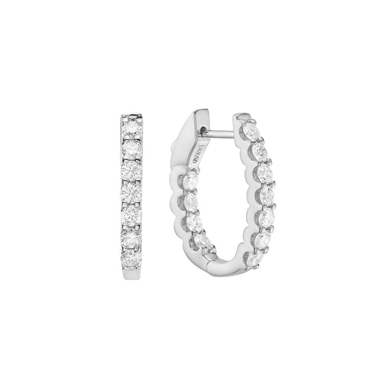 Close up view of the white gold prong-set diamond hoop earrings. Showcasing inside-out diamond detailing and a scalloped setting.