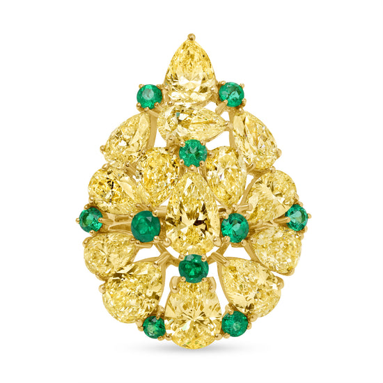 Close up of the Fancy Yellow Diamond and Emerald Ring. Featuring 14 pear-cut fancy yellow diamonds and 10 round green emerald gemstones set in 18k yellow gold.