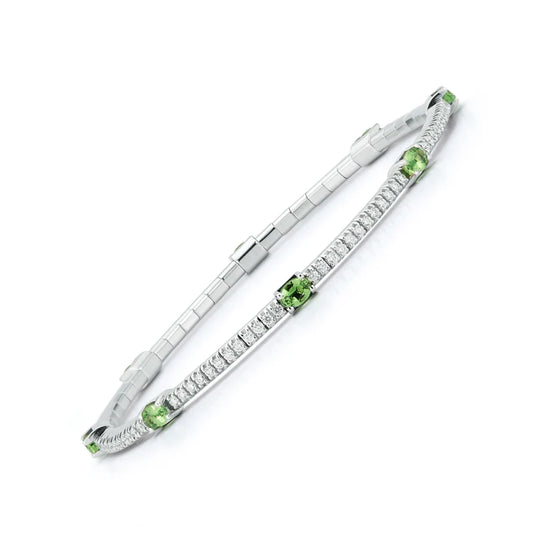 Close up view of the diamond and green tsavorite bracelet. With 2.45 carats of round white diamonds and green tsavorites set in 18k white gold.