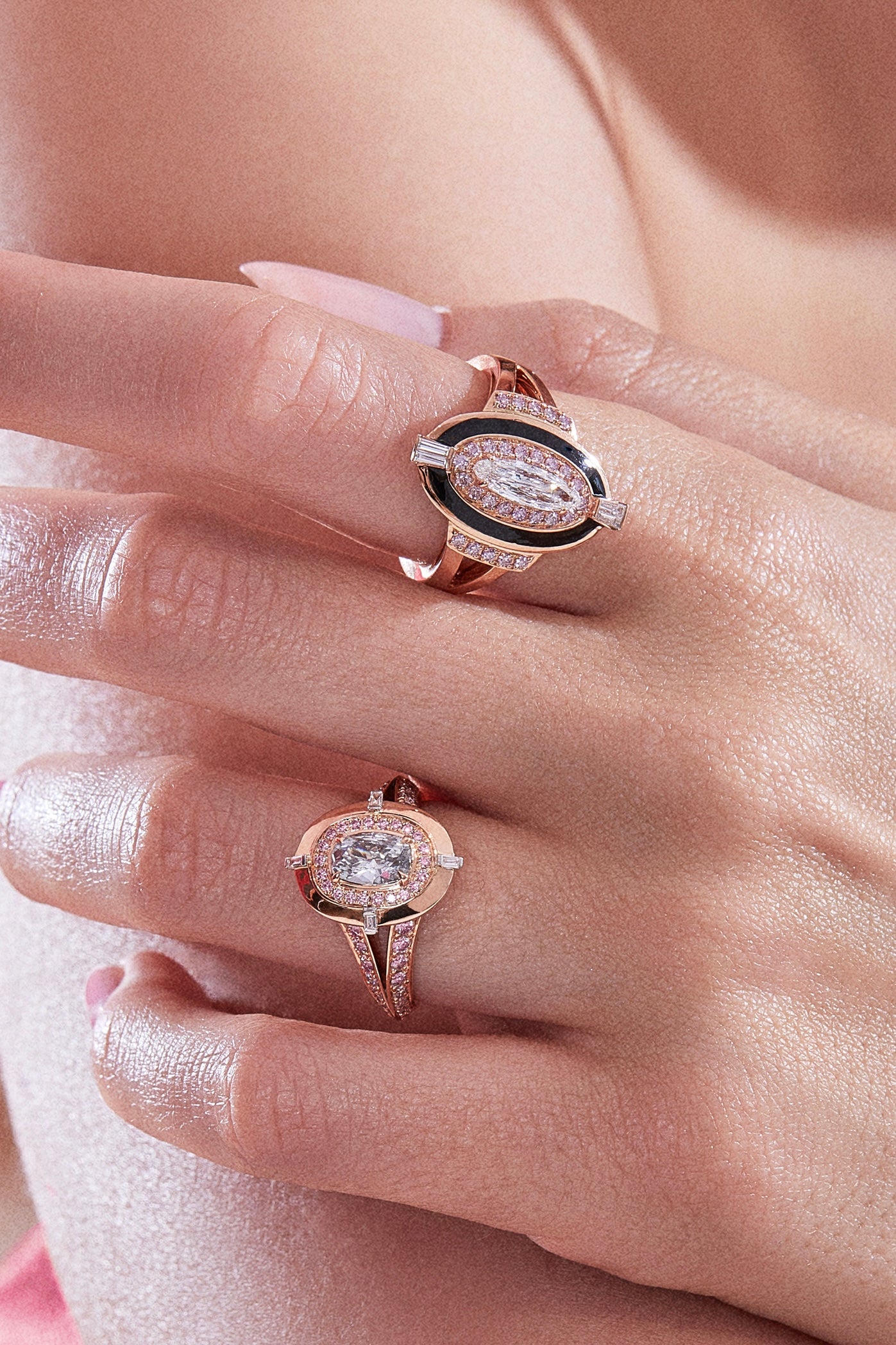 Two oval diamond cocktail rings on a woman&