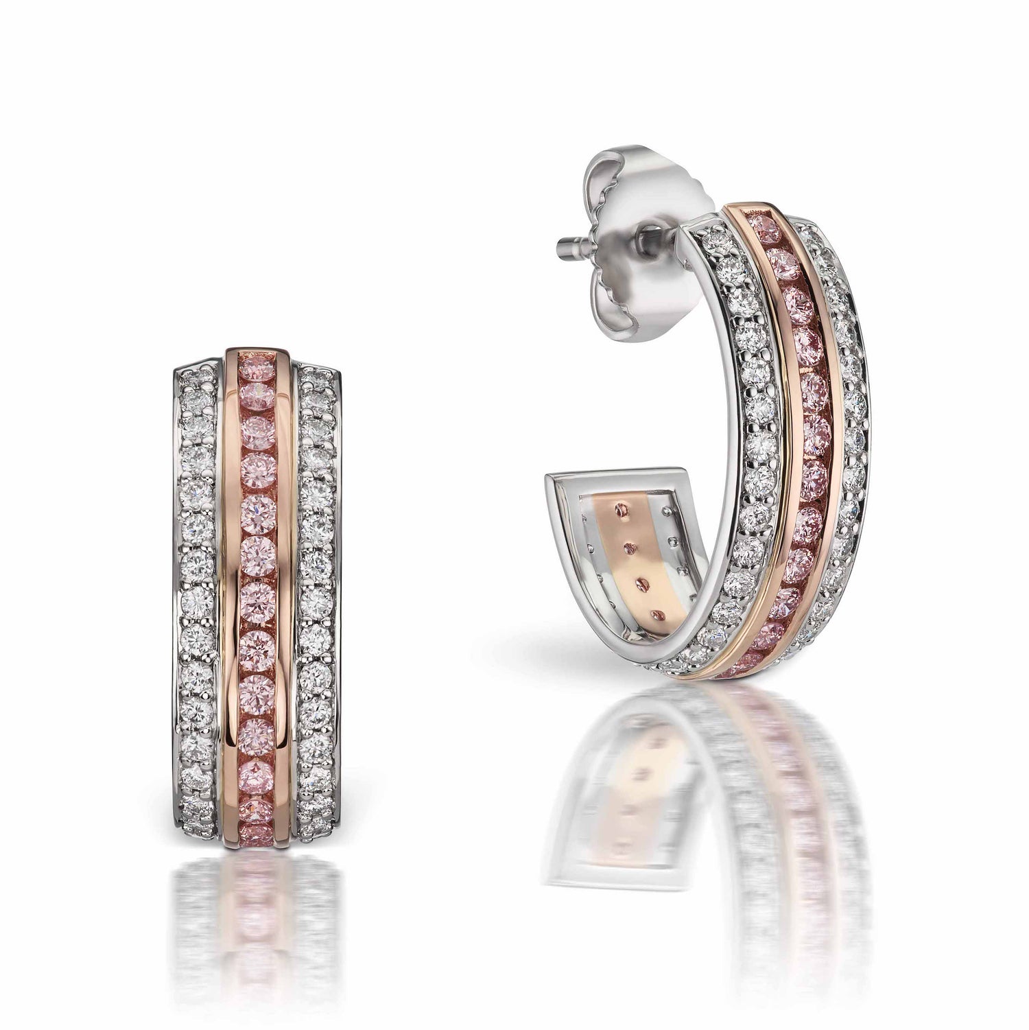 Close up view of the Argyle Pink and White Diamond Huggie Earrings set in platinum and 18k pink gold. 