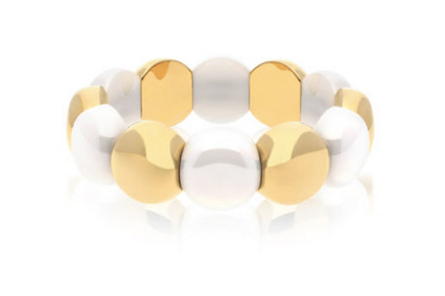 Alternating white ceramic and 18K yellow gold domes on a stretch bracelet