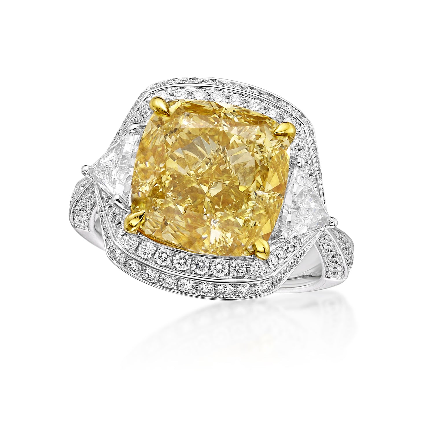 close up of the fancy yellow diamond engagement ring, with white diamonds on either side, around the center stone, and along the ring band. 