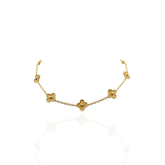 Close up view of the VCA Necklace, (also known as the Alhambra Necklace) featuring ten clover motifs in 18K yellow gold.