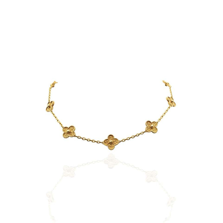 Close up view of the VCA Necklace, (also known as the Alhambra Necklace) featuring ten clover motifs in 18K yellow gold. 